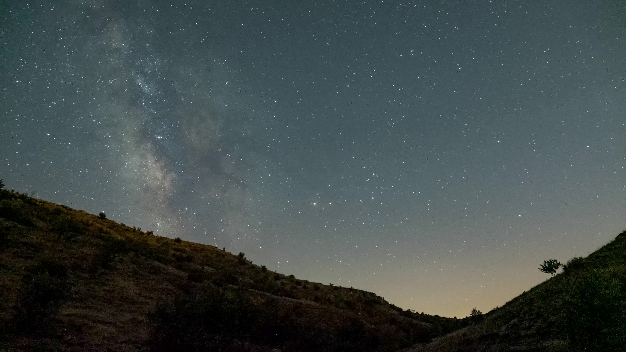 The Milky Way over hills at night